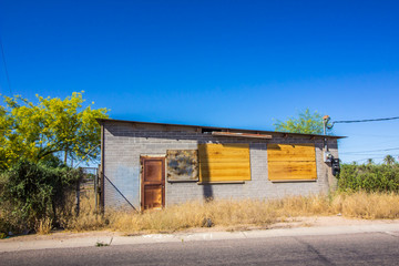 Old Abandoned One Level Building With Blocked Out Windows