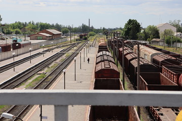 Old and rusty railway cars and trains are standing at the station. Commodity and passenger cars.