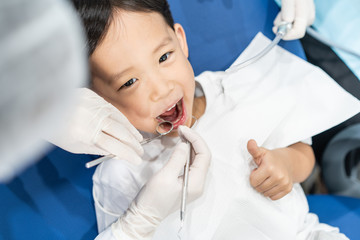 A boy having teeth examined at dentists: Healthy lifestyle, healthcare, and medicine concept.