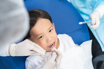 Fototapeta premium A boy having teeth examined at dentists: Healthy lifestyle, healthcare, and medicine concept.