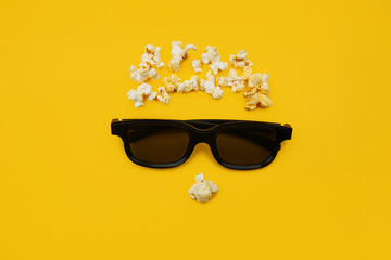 Abstract image of viewer, 3D glasses and popcorn on yellow background. Concept cinema and entertainment.