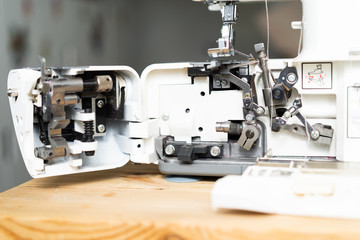 repair of sewing equipment, overlock. hand and a screwdriver fixes the breakage sewing machine
