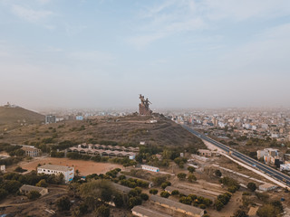 a huge monument on Africa's independence mountain with a view of the city photographed from the throne