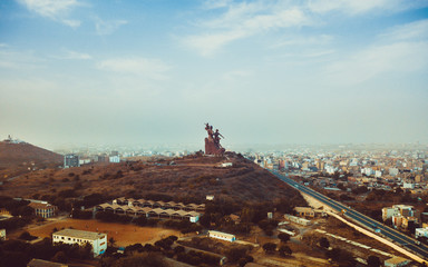 a huge monument on Africa's independence mountain with a view of the city photographed from the throne - obrazy, fototapety, plakaty