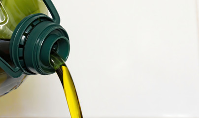 oil bottle pouring olive oil with white background