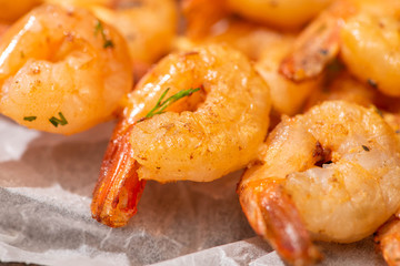 close up view of crispy prawns on parchment paper