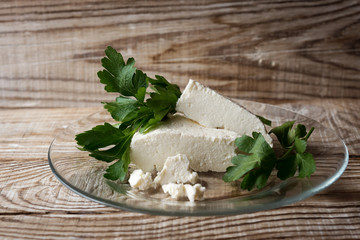 homemade Adyghe cheese on a wooden background