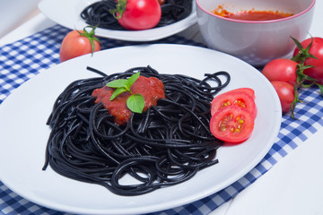 Spaghetti pasta with and tomato sauce on wood background