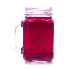 Glass of red grape juice with fruit isolated on white