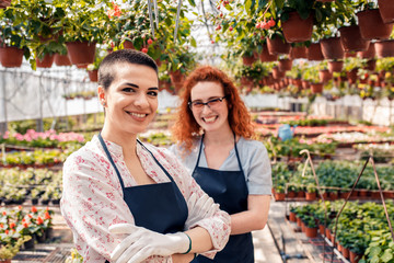 Portrait of two female florists in a greenhouse.