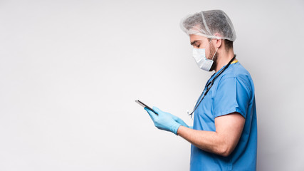 Side view male nurse browsing tablet