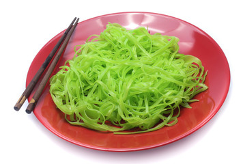 green noodles on dish isolated on white background