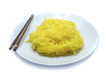 yellow noodles on dish isolated on white background