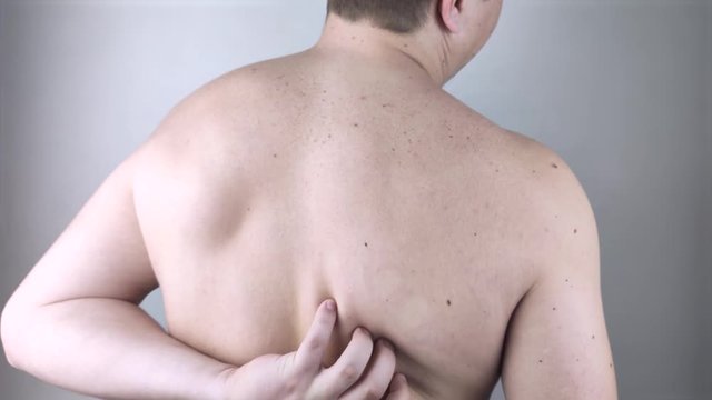 Shoulder pain. A man at a doctor&rsquo;s appointment with a vertebrologist complaining of pain in the interscapular region and back.
