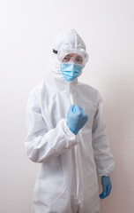 Fototapeta premium Young male doctor raised fist up In protective clothes, Celebrating his success