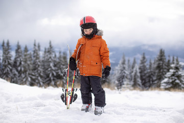Children's skiing. Winter sport for children. Family Christmas holiday. Children learn to ski. A...