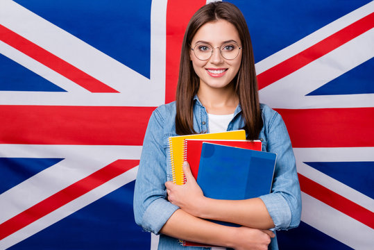 Close-up portrait of her she nice attractive smart clever cheerful cheery girl holding in hands exercise book lesson classes courses isolated over british stripes flag background