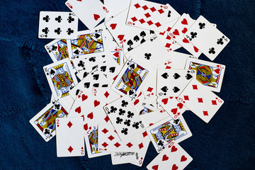 playing cards are scattered all over the blue background