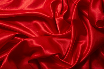 Fototapeta premium Luxury red satin smooth fabric background for celebration, ceremony, event invitation card or advertising poster