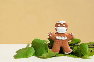 Gingerbread man with protective face mask - concept in coronavirus (COVID-19) time