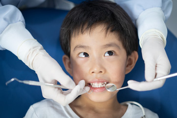 A boy having teeth examined at dentists: Healthy lifestyle, healthcare, and medicine concept.