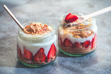 Two jar of strawberry pudding magnolia desert over rustic backdrop