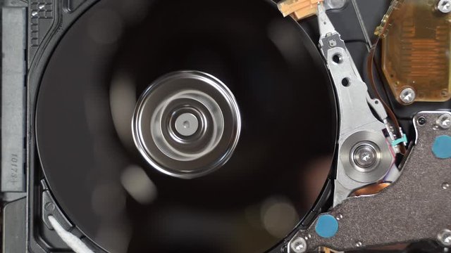 Open Hard Disk Drive HDD reading data from magnetic platter, interior of computer