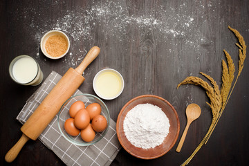 Top view of ingredients bakery making on black wooden table
