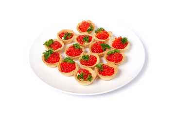 Tartlets with red caviar on a white plate. Gourmet food, appetizer. salmon caviar. Deli. Gourmet food. Seafood. On white highlighted background.