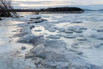 Blue ice on the Volga river round shape in the form of a pancake at sunrise