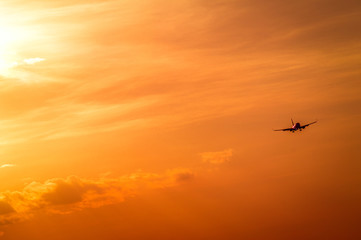 The plane is in the sky, the plane is landing. Plane in the west