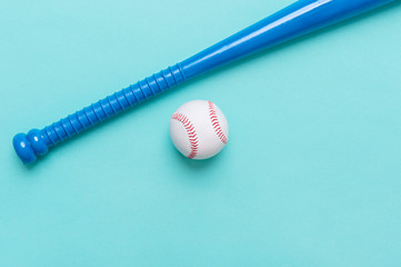 Blue baseball bat and ball isolated on blue background