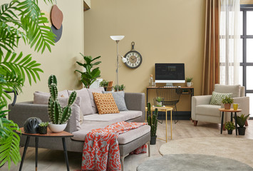 Brown living room, botanic interior style, grey sofa bookshelf and lamp concept.