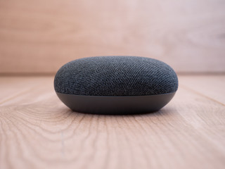 close up mini smart home speaker device on wooden background