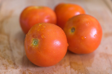 Close up shot of fresh tomatoes on wooden chopping board.Selective focus.