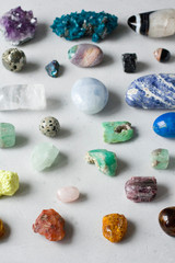 Beautiful bright multi-colored collection of natural stones and minerals from around world lies on...
