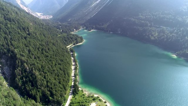 Aerial view of Lago del Predil. From road, revealing lake and surrounding mountains. Rabeljsko jezero.