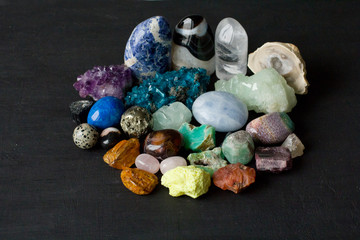 Beautiful bright multi-colored collection of natural stones and minerals from around world lies on...