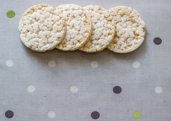 Rice round snacks on a gray background. Healthly food. Diet. Gluten free. Snacks for diabetics. Eco food. Dry bread for fitness. Sport lifestyle.