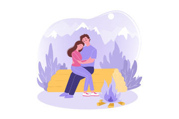 Obraz premium Travelling couple, love, hiking, tourism, nature, camping concept. Happy couple in love man woman tourists hikers sitting and hugging on log near bonfire. Vacation trip active lifestyle and recreation
