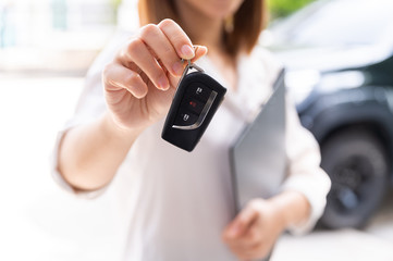 Car loan, contract agreement,buying and rent car concept, Saleperson holding car key on hand