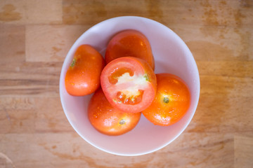Close up shot of fresh tomatoes on wooden chopping board.Selective focus.