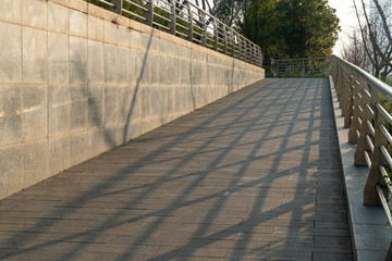 A wheelchair ramp, an inclined plane installed in addition to or instead of stairs, Slope walkway for disabled people, people pushing strollers, carts with stainless bars to prevent falling