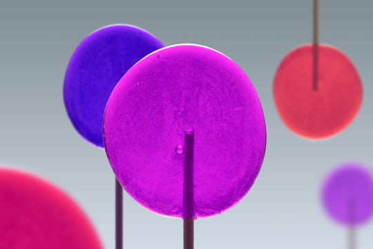 Colorful Sweet Lollipops of Pink, Violet and Red Colors. Round Candies on Stick. Trick or Treat.