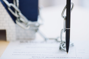 Selective focus of pen with chain on white background