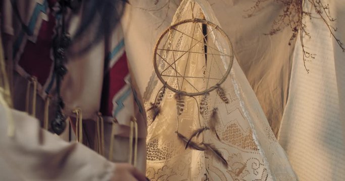 Mother is taking her child out of the cradle, native american people, 4k