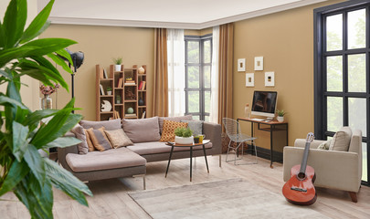 Brown living room, grey sofa wooden bookcase and carpet detail.
