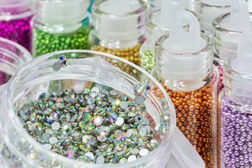 Rhinestones for nails box. Вifferent colorsr in bottles for the design of nails.