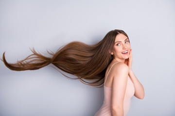 Profile photo of attractive cute model lady demonstrating ideal neat long healthy hairstyle flying on air after lamination procedure wear beige singlet isolated grey color background - obrazy, fototapety, plakaty
