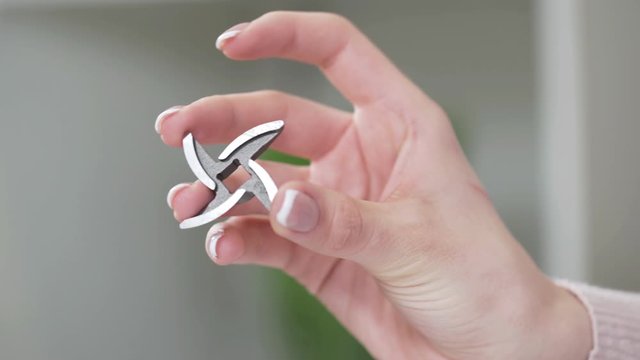 Female hand holds knife for providing high-quality mince from all types of meat. Electric mincer machine for minced meat per minute, make sausages, mashed berries, squeeze juice and chop vegetables.